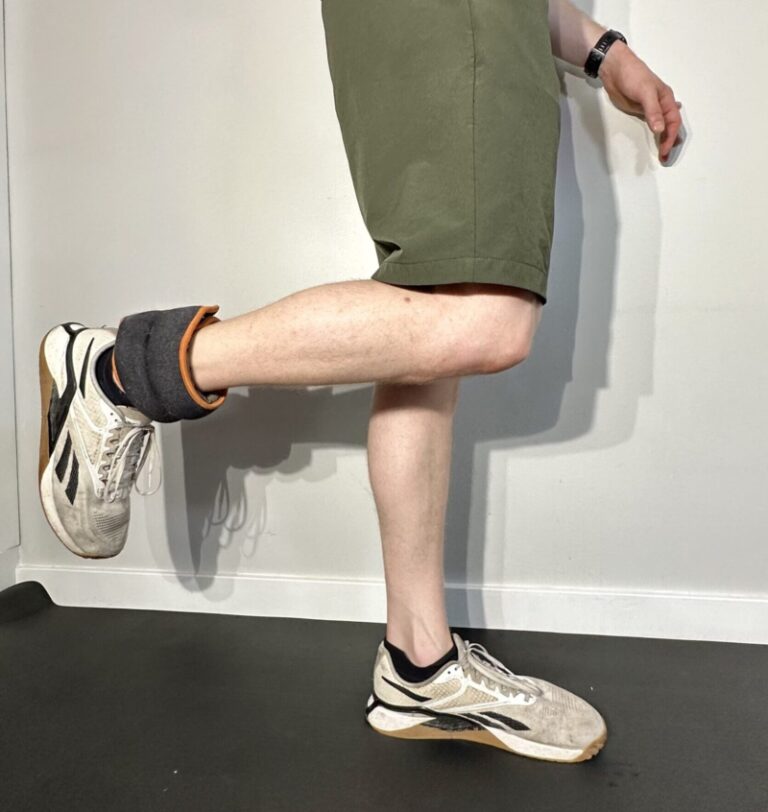 Demonstration of a standing hamstring curl with an ankle weight