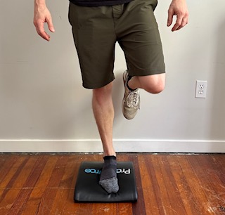 I am demonstrating how to perform balancing on one leg, using a foam pad for improvements of balance with physical therapy exercises