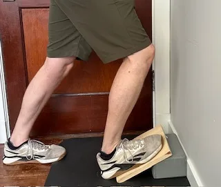 I'm demonstrating a soleus stretch on a slant board