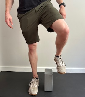 I'm demonstrating a cone step over to work on the mobility of the knee and progressing to a weightbearing activity