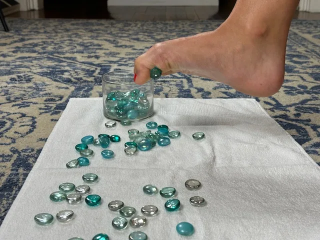 demonstration of a marbil pick-up exercise to strengthen foot intrinsic muscles for treating plantar fasciitis