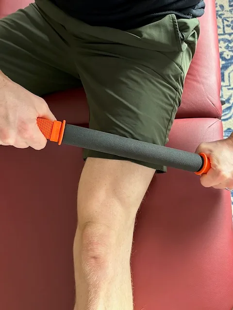 Demonstrating soft tissue mobilization to the quad muscle with a Tiger Tail