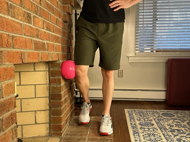Demonstrating the ball against wall exercise to strengthen the gluteus medius muscle for the treatment of gluteal tendinopathy