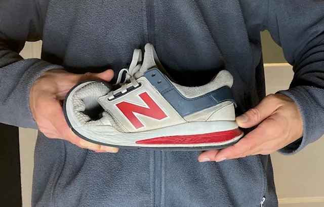 demonstrating the reduced flexibility in a standard tennis shoe