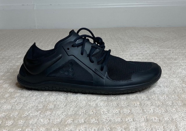 A black, vivobarefoot, minimalist shoe that is great for people with bunions