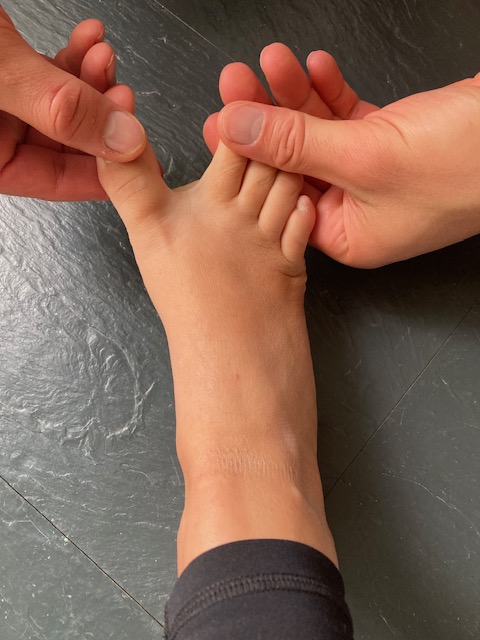 demonstrating great toe abduction exercise to increase space between toes