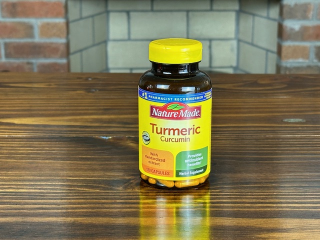 bottle of curcumin supplement in the form of turmeric used to reduce pain and inflammation associated with knee osteoarthritis