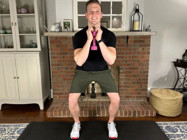 Physical therapist with proper form during goblet squats to build compound leg strength for climbing stairs