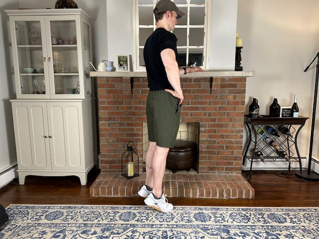 PT demonstrating standing heel and toe raises for osteochondral lesion rehab; strengthens lower leg for walking stability