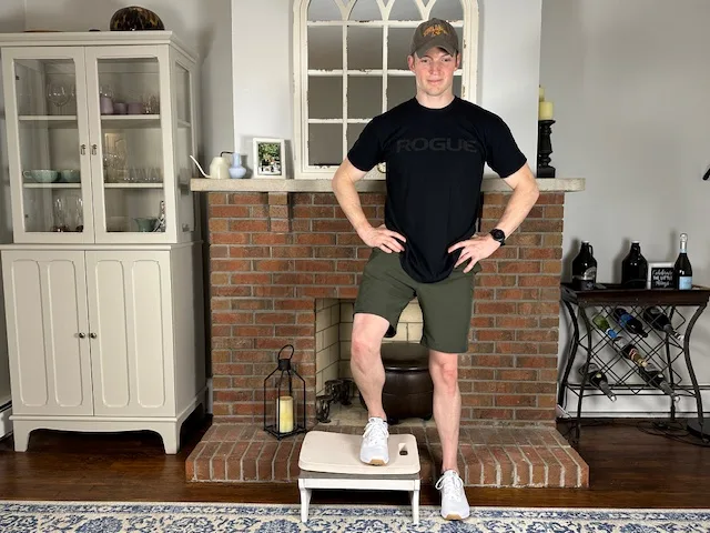 PT demonstrating lateral step over drill to train balance and coordination after quad injury