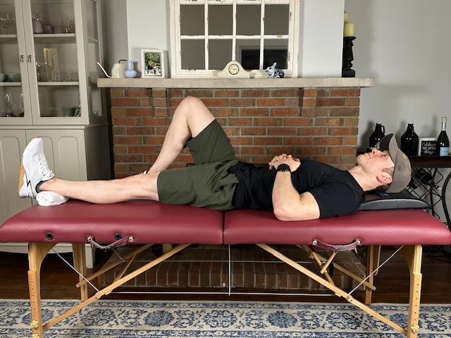 Straight-leg quad set with towel under ankle to encourage full knee extension and gentle quad activation