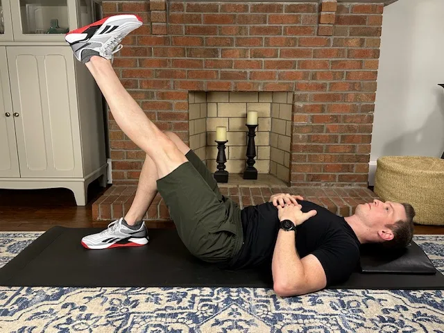 Straight leg raise for quad activation with osteochondritis dissecans, demonstrated by a physical therapist