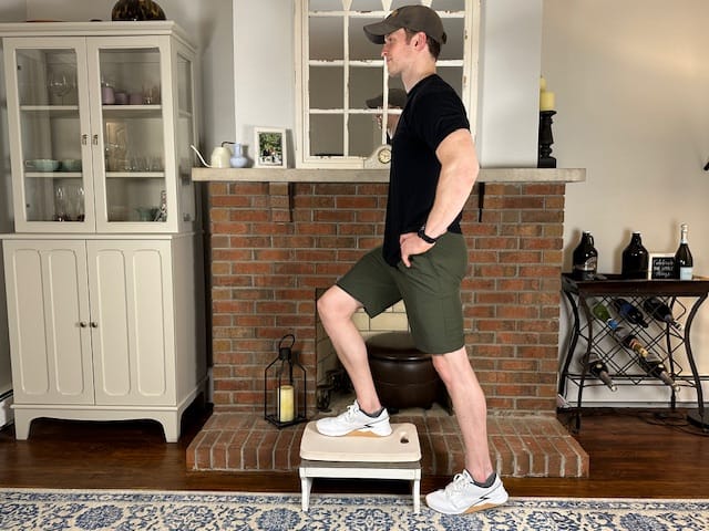 Step-up exercise on platform to build quad and glute strength during mid-phase recovery